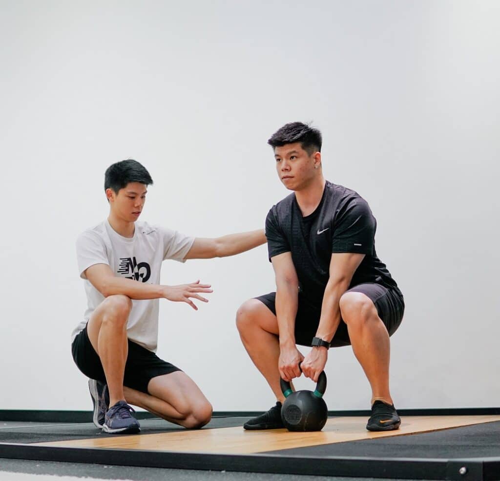 kettlebell squat with a personal trainer